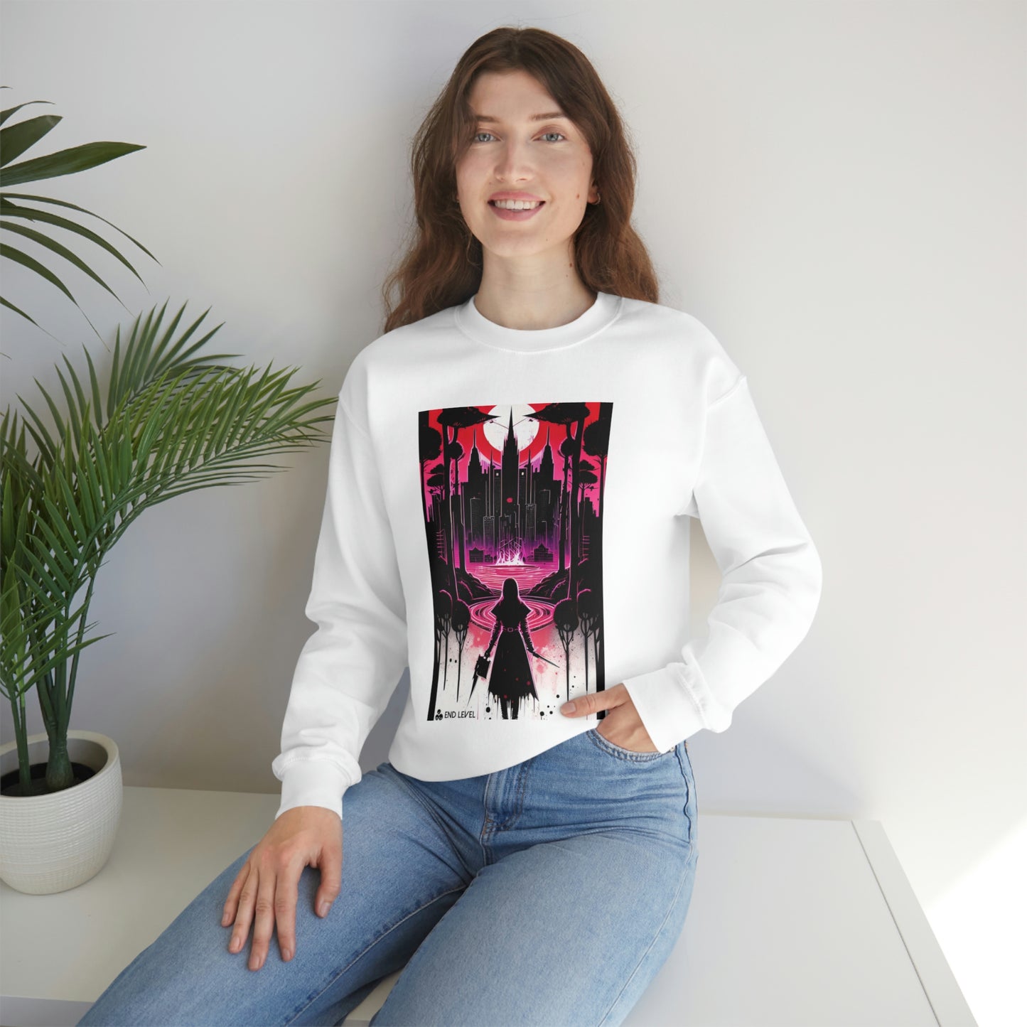 Woman with hand in jean pocket wearing purple Night Of Malice sweatshirt beside plant.