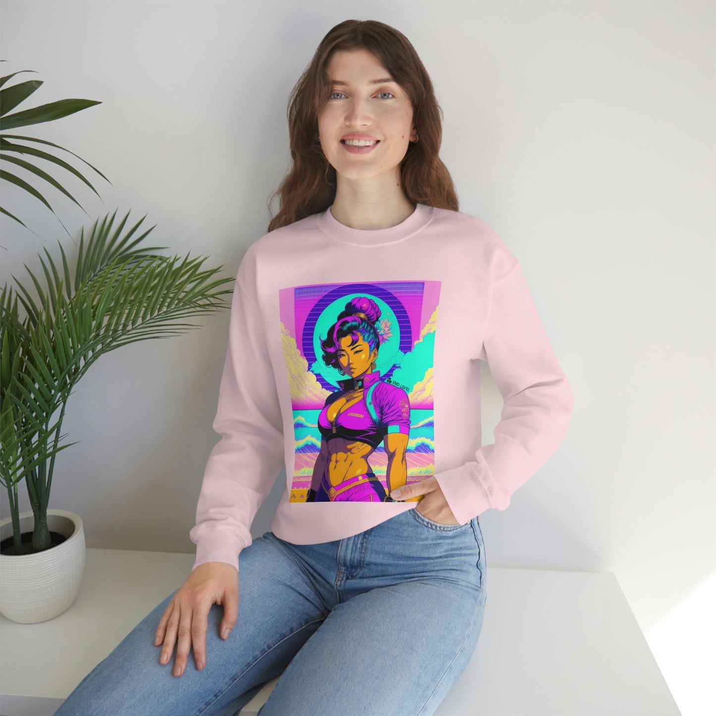 Woman with hand in jean pocket wearing pink Lady Lotus sweatshirt beside plant.